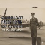A black and white photo of a World War II-era Supermarine Spitfire aircraft in flight, representing the service of Squadron Leader Paddy Flynn.
