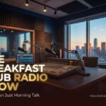 The hosts of The Breakfast Club radio show sitting in their studio, smiling and talking into microphones.